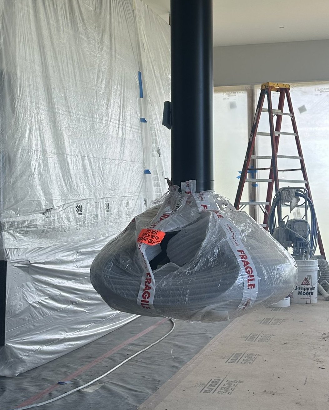 Freestanding fireplace delivery and installation in progress in a luxury new construction home in Teton Valley